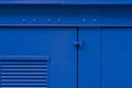 Blue painted iron wall with door Royalty Free Stock Photo