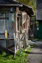 Blue painted metal house nameplate or street sign with six digit on wooden wall of barn near out of focus rural house Royalty Free Stock Photo