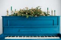 Blue painted old piano decorated with Christmas garland Royalty Free Stock Photo