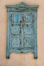 old wooden window with closed shutters on beige house wall Royalty Free Stock Photo