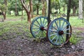 Blue painted wagon wheels near the entrance of a Cuban public park