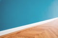 Blue painted wall and wooden parquet floor - renovation background