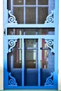 Blue painted wood Victorian screen door scrollwork