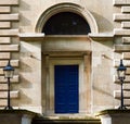 Blue wooden Door with symmetrical lighters on sides