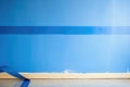 blue painters tape edges against a freshly painted wall