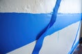 blue painters tape edges against a freshly painted wall