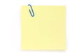 Blue paper clip with yellow notepaper Royalty Free Stock Photo