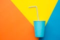 Blue Paper Cups With Drinking Colored Plastic Straws On Beautiful Multicolored Background. Set For Party. Top View. Minimalist