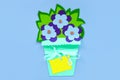 Blue paper flowers with leaves in a basket on a purple background, greeting card tag mockup. Floral arrangement flat lay