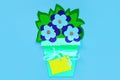 Blue paper flowers with leaves in a basket on a purple background, greeting card tag mockup. Floral arrangement flat lay