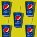 Blue paper glass with Pepsi. Takeaway carbonated drink in a cap and straw. Brand logo. Glasses pattern. Yellow