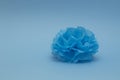 Blue paper pompom for a decoration on blue background. Home, wedding, party decoration. Background in minimal style. Royalty Free Stock Photo