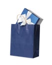 Blue paper shopping bag with gift box on white background Royalty Free Stock Photo