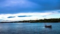 Blue Paradise. Lonely dinghy boat on the water. View of Sarasota Bay, Florida near Siesta Key Beach at sunset Royalty Free Stock Photo