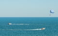 Blue parasail wing pulled by a boat in the sea water, Parasailing also known as parascending or parakiting Royalty Free Stock Photo