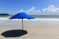 Blue parasol on a deserted beach Royalty Free Stock Photo