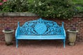 Blue Park Bench in a Public Country Garden Royalty Free Stock Photo