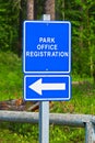 A blue park office registration direction sign