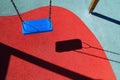 Blue park swing or red floor children playground Royalty Free Stock Photo