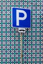 Blue parking sign in front of blue and green Azulejo tiles in Lisbon, Portugal