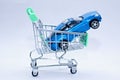 Blue passenger car in a shopping cart. Royalty Free Stock Photo