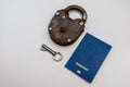 Blue passport with old lock and key on a white background. Coronavirus and travel concept Royalty Free Stock Photo