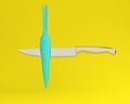 Blue pastel Carrot impaled on stainless kitchen knives on yellow Royalty Free Stock Photo