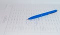 Blue pen lying on paper documents