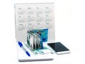 Blue pen and Notepad on a white background, phone and money, Russian money and calendar