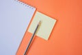 Pencil and notepad on orange background Royalty Free Stock Photo