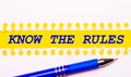 Blue pen and white torn paper stripes on a bright yellow background with the text KNOW THE RULES