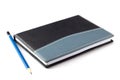 Blue pencil on black leather moleskin notebook Royalty Free Stock Photo