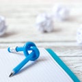 Blue Pencil with knot on writing pad on white wood background Royalty Free Stock Photo