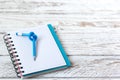 Blue Pencil with knot on writing pad on white wood background Royalty Free Stock Photo