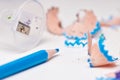 Blue pencil sharpening creating creative wood shavings close up Royalty Free Stock Photo