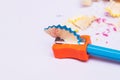 Blue pencil sharpening in orange pencil sharpener. School pencil sharpener. Office pencil sharpener Royalty Free Stock Photo