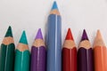 Blue pencil standing out from a row of colored pencils Royalty Free Stock Photo