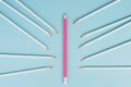 Blue pencils point to the pink one, standing out from the crowd concept, be different, leadership, mobbing Royalty Free Stock Photo