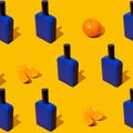 Blue perfume bottle with mandarin slices on a orange background. Fresh citrus fruits flavor concept. Style Pattern with