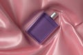 A blue perfume bottle on a pink shiny fabric