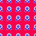 Blue Pet award symbol icon isolated seamless pattern on red background. Badge with dog or cat paw print and ribbons Royalty Free Stock Photo