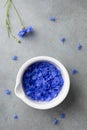 Blue petal of cornflowers in bowl for medical and cosmetic products. Flat lay style and top view