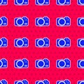 Blue Photo camera icon isolated seamless pattern on red background. Foto camera. Digital photography. Vector Royalty Free Stock Photo