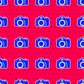 Blue Photo camera icon isolated seamless pattern on red background. Foto camera. Digital photography. Vector Royalty Free Stock Photo