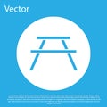 Blue Picnic table with benches on either side of the table icon isolated on blue background. White circle button. Vector