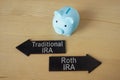 Blue piggy bank and arrows Traditional and Roth IRA. Royalty Free Stock Photo