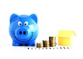 Blue piggy bank and coins stack and house paper for Home loans c