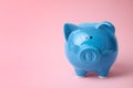 Blue piggy bank on color background Royalty Free Stock Photo