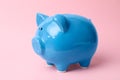 Blue piggy bank on color background. Royalty Free Stock Photo