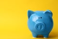 Blue piggy bank on color background. Royalty Free Stock Photo